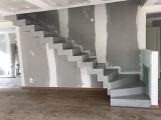 an empty room with some stairs painted white