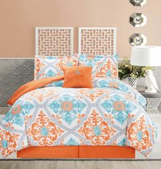 an orange and blue bed in a bedroom