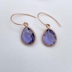 Elegant Rose Gold Tanzanite colored glass teardrop pendant earrings are a medium shade of purple. The teardrops are attached to rounded Rose Gold filled ear wires.  Tanzanite is the birthstone for December. Earring  Measurements:  1-1/4 inch drop Teardrop pendant: Rose Cut Tanzanite Glass Teardrop Pendant Pendant Measurements: Height - 12.5mm Width: - 8mm Ear Wires 14K Rose Gold Filled Ear Wires Size 20mm  There is another style of these earrings which are more of a longer dangle:  https://www.e Purple Gemstone Teardrop Earrings, Lavender Teardrop Jewelry With Ear Wire, Lavender Teardrop Nickel-free Jewelry, Lavender Teardrop Earrings With Ear Wire, Faceted Teardrop Earrings As Gift, Faceted Teardrop Earrings For Gifts, Purple Pendant, Tanzanite Pendant, Earrings Purple