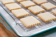 some cookies are cooling on a rack and ready to go into the oven for baking