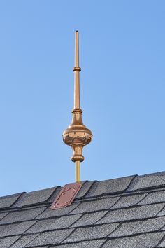 a weather vane on the roof of a house