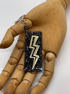 This Etsy listing is for one rectangle acrylic keychain.   This particular keychain features black and gold holographic glitter and metallic gold lightening bolt details. The acrylic rectangle measures 2 3/4 inches wide, 1 1/4 inches tall and hangs 4 1/2 long including chain.  It is made from acrylic, adhesive vinyl, glitter and UV resin. Acrylic Keychain, Holographic Glitter, Uv Resin, Adhesive Vinyl, Metallic Gold, Black And Gold, Keychains, Handmade Natural, Etsy Listing