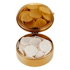 an open gold box filled with cookies and marshmallows on a white background