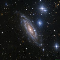 a spiral galaxy with stars in the background