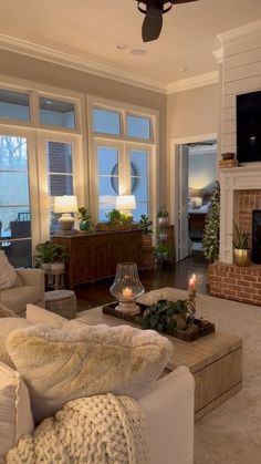 a living room filled with furniture and a flat screen tv mounted on the wall above a fire place