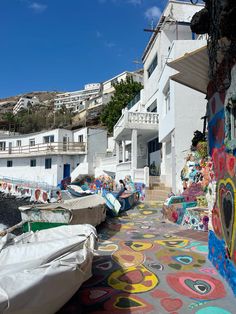 colorful street art on the side of a white building with lots of windows and balconies