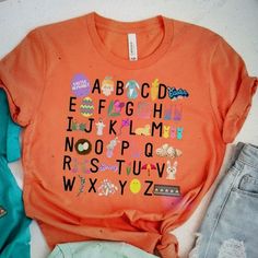 Easter Teacher Alphabet Shirt - Teacher Easter Shirt - Easter Shirt For Teachers - Teacher Easter - Happy Easter Shirt Color: Orange Size: Large Bought The Wrong Size For My Daughter - Brand New Never Worn Bundle To Automatically Save 15% On Three Items! Bundle Multiple Likes And I Will Send A Special Offer! Great Reviews Lightning Fast Shipping Non-Smoking Home No Trades Please Spring Orange Shirt With Graphic Print, Fun Printed Spring Shirt, Fun Crew Neck Shirt For Spring, Fun Spring Crew Neck Shirt, Playful Crew Neck Shirt For Spring, Playful Crew Neck Spring Shirt, Spring Crew Neck Playful Shirt, Spring Playful Crew Neck Shirt, Fun Orange T-shirt For Spring