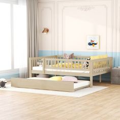 a baby's room with a bed, crib and toys on the floor