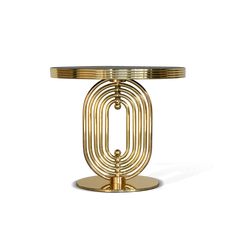 a gold table with an oval glass top and circular metal base, on a white background