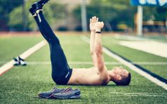 a man doing push ups on the ground with his hands in the air and one leg up