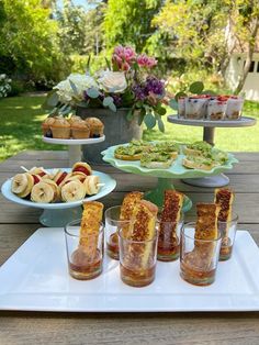 several desserts and snacks on a table outdoors