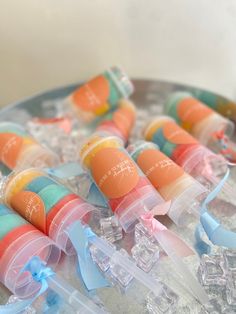 several small containers filled with different types of toothpaste on top of an ice tray