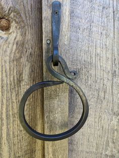 a close up of a metal hook on a wooden door