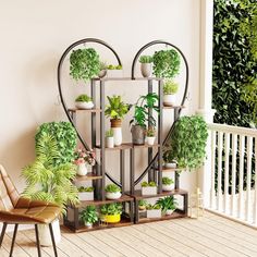 a heart shaped shelf filled with potted plants on top of a wooden floor next to a chair