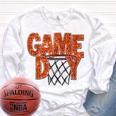 an orange and white shirt with the words game day on it next to a basketball