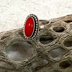 Bright red Coral gemstone set in sterling silver ring, made to your size. Love a little pop of color?  One of these coral rings is the perfect addition to your jewery lineup.   These coral settings are unfinished so you can choose to have one finished in the ring size of your choice. Your ring will be finished with a hammered band as shown in the pictures (band is not yet soldered).  Having a hammered single band allows you to wear your ring with other stacking bands you may own. The settings are 1/2 X 3/4 inches.  The coral stones are surrounded by a fine silver bezel, set in sterling silver and accented with either a twist or bead wire. Choose your favorite look and I will use that exact setting.  These little lovelies are designed and made by me in my Arizona studio. Arriving in one of Coral Rings, Red Coral Ring, Red Gemstone Ring, Bead Wire, Coral Gemstone, Hammered Band, Stacking Bands, Coral Ring, Coral Stone