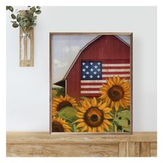 an american flag and sunflowers painted on a wooden frame in front of a barn