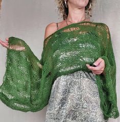 Wrap yourself in this hand-knit green mohair wrap, an ethereal blend of style and comfort. Featuring a loose-knit design, this forest green boho shrug adds a dreamy touch to any outfit. Its sheer knit texture and airy open-weave make it perfect for layering as a fairly core sweater or a festival top. This unique handcrafted mohair piece is eco-friendly and versatile, embodying bohemian artistry with a vintage-inspired flair. Perfect for adding a natural, forest green accent to your wardrobe. Mohair and acrylic blend yarns were used to make the sweater. Available Sizes and Measurements; "XS" size Shrug (approx.); Shoulder 13" 33cm Neckline opening: 11"  28cm Length ( from top of the shoulder to waistline): 11"  28cm Sleeve Length: 21"  53cm "S" size Shrug (approx); Shoulder: 14"  36cm Neckl Boho Shrug, Knit Mohair Sweater, Boho Festival Outfit, Sweater Shrug, Pull Mohair, Poncho Pullover, Natural Forest, Statement Outfit, Shrugs And Boleros