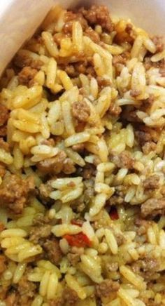 a bowl filled with pasta and meat on top of a table