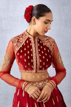 Bright red hand embroidered choli in silk velvet having sheer sleeves in butterfly net.
Component: 1
Pattern: Embroidered
Type Of Work: Floral
Neckline: Round
Sleeve Type: Sheer
Fabric: Silk Velvet,Butterfly Net
Color: Red
Other Details: 
Eye shape padded
Note: Lehenga worn by the model is not for sale
Occasion: Wedding - Aza Fashions Velvet Blouse Designs Latest, Velvet Choli, Hand Embroidered Blouse, Arabian Dress, Butterfly Net, Silk Velvet Fabric, Indian Bridal Lehenga, Velvet Blouses, Bridal Blouse Designs