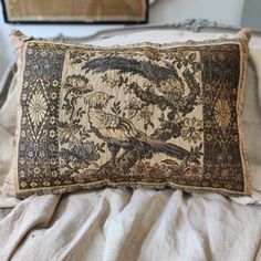 a decorative pillow on top of a bed