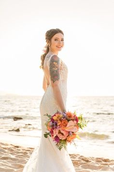 a woman in a wedding dress on the beach