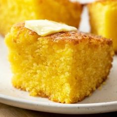 two pieces of cornbread on a white plate