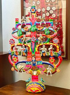 a brightly colored vase sitting on top of a wooden table