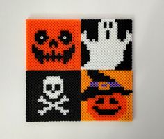 four halloween themed coasters made out of perler beads with different designs on them