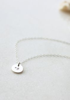 Our sweet, tiny dot, stamped with one of our little symbol stamps. A solid 9mm disc is hand-stamped. Use the drop down box to select 16", 18", or 20" length. Different chain length can be requested using 'Notes' at checkout. Handmade in Eau Claire, WI. All of our jewelry is handmade to order just for you so each piece will be unique and may vary slightly from what is pictured. Due to its handmade nature, please allow 3-5 business days for orders to ship. Anniversary Dainty Hand-stamped Charm Necklace, Dainty Hand Stamped Initial Necklace As Gift, Dainty 14k Stamped Initial Pendant Necklace, Dainty Hand Stamped Initial Pendant Charm Necklace, Dainty Heart-shaped Hand Stamped Charm Necklace, Poppy Ring, Everyday Wear Jewelry, Dot Necklace, Unique Silver Jewelry