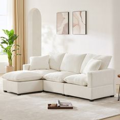 a living room with a white sectional couch