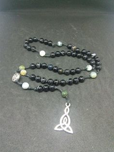 This is a beautiful re-imagined rosary based on the classic Catholic rosary. The beads are evil eye agate and fancy jasper. There are five decades of nine beads each. The center is a Celtic knot, and I have capped it off with a triad pendent. With this rosary I'm including a simple chant which has resonated with me, but feel free to use your own! Pagan/witch prayer chant: Knot one, the work's begun. Knot two, my aim is true. Knot three, it will be. Knot four, power's stored. Knot five, the work' Spiritual Rosary With Round Beads For Meditation, Spiritual Gemstone Beads Rosary, Spiritual Beaded Rosary As Gift, Spiritual Rosary For Meditation With Round Beads, Bohemian Adjustable Rosary Bracelet With 108 Beads, Bohemian Hand-strung Healing Rosary, Bohemian Hand-strung Rosary For Healing, Spiritual Rosary With 8mm Beads, Meditation Rosary With 108 Beads