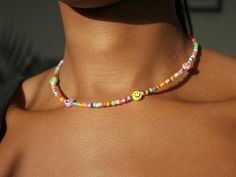 ☆ Item ☆ Necklace length: 40cm  A unique handmade colourful beaded necklace with colourful smiley charms (7mm) ) with a silver stainless steel finish. A must have for all seasons! Need an adjustment? Please feel free to message me before buying :). ☆ Care ☆ Each piece of jewellery is handcrafted with great attention to detail. I go to great lengths to ensure durability; however, please keep in mind that jewellery, in general, is fragile, so handling your necklace with care is recommended! To kee Cheerful Colorful Beads Jewelry For Gifts, Playful Tiny Beads For Gifts, Fun Beaded Necklaces For Gifts, Fun Beaded Necklaces With Tiny Beads For Gifts, Fun Beaded Necklace With Tiny Beads For Gift, Summer Beaded Necklace, Pastel Necklace, Pearl Necklace Choker, Pearl Charm Necklace