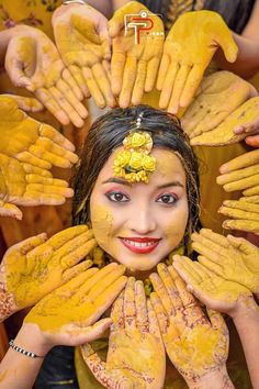 a woman with yellow paint on her face and hands