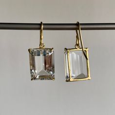 Sparkling white topaz in subtle gold frames make a classic statement in this stunning pair. 18k yellow gold White topaz 13mm x 16mm (1/2" x 5/8")Earrings hang 1 1/8" from the ear Each earring weighs 4.1g Gold Jewelry With White Topaz Emerald Cut, Gold Emerald Cut White Topaz Jewelry, White Topaz Emerald-cut Jewelry, Classic Diamond White Emerald-cut Earrings, Timeless Emerald-cut Earrings With Diamond Accents, White Topaz Earrings, Gold Frames, Newport Ri, Topaz Earrings