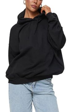 A slouchy, oversized fit lets you enter full relaxation mode the minute you slip on this cozy hoodie. Drawstring hood   Ribbed cuffs and hem   52% recycled polyester, 48% organic cotton   Machine wash, line dry   Imported Casual Baggy Hoodie With Ribbed Cuffs, Comfortable Black Hoodie For Fall, Comfy Black Hoodie For Fall, Comfy Oversized Black Sweatshirt, Comfy Black Relaxed Fit Hoodie, Baggy Fall Hoodie With Ribbed Cuffs, Baggy Hoodie With Ribbed Cuffs For Fall, Baggy Hooded Hoodie With Ribbed Cuffs, Baggy Winter Hoodie With Ribbed Cuffs