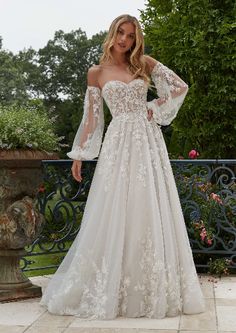 a woman in a wedding dress posing for the camera