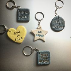 four different key chains with words on them