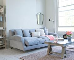 a living room filled with furniture next to a window