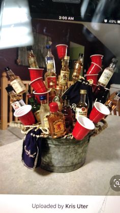 a bucket filled with lots of liquor bottles