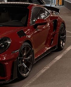 a red sports car parked in a parking lot