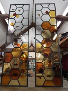 two large stained glass windows sitting inside of a building