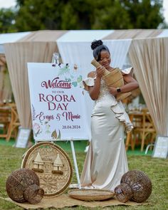 a woman standing in front of a sign holding a piece of bread