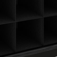 a black bookcase with four shelves on one side and two doors on the other