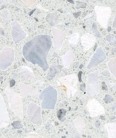 a close up view of some rocks on the ground with white and gray colors in it