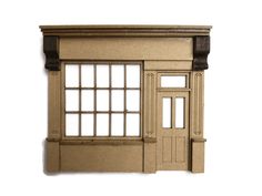 a cardboard model of a building with windows and doors on the outside, against a white background