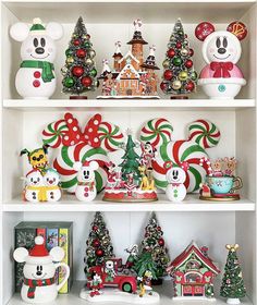 mickey mouse figurines and christmas decorations on shelves