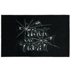 a black rug with the words trick or treat written in white chalk on it and spider webs