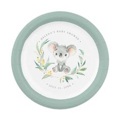 a white and green plate with a koala bear on it