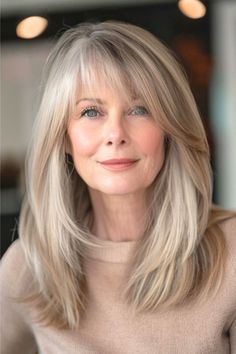 This fabulous mane has a cascade of buttery blonde wispy layers that provide fullness and add a youthful touch to the look. The long, side-swept bangs frame the face beautifully while allowing for versatile styling options. Click here to see more stunning hairstyles for women over 60 with bangs. Waterfall Bangs, Med Haircuts, Subtle Bangs, Characters Profile, Wispy Layers, Hair Fancy, Subtle Fringe, Hair Color Blonde Highlights, Buttery Blonde